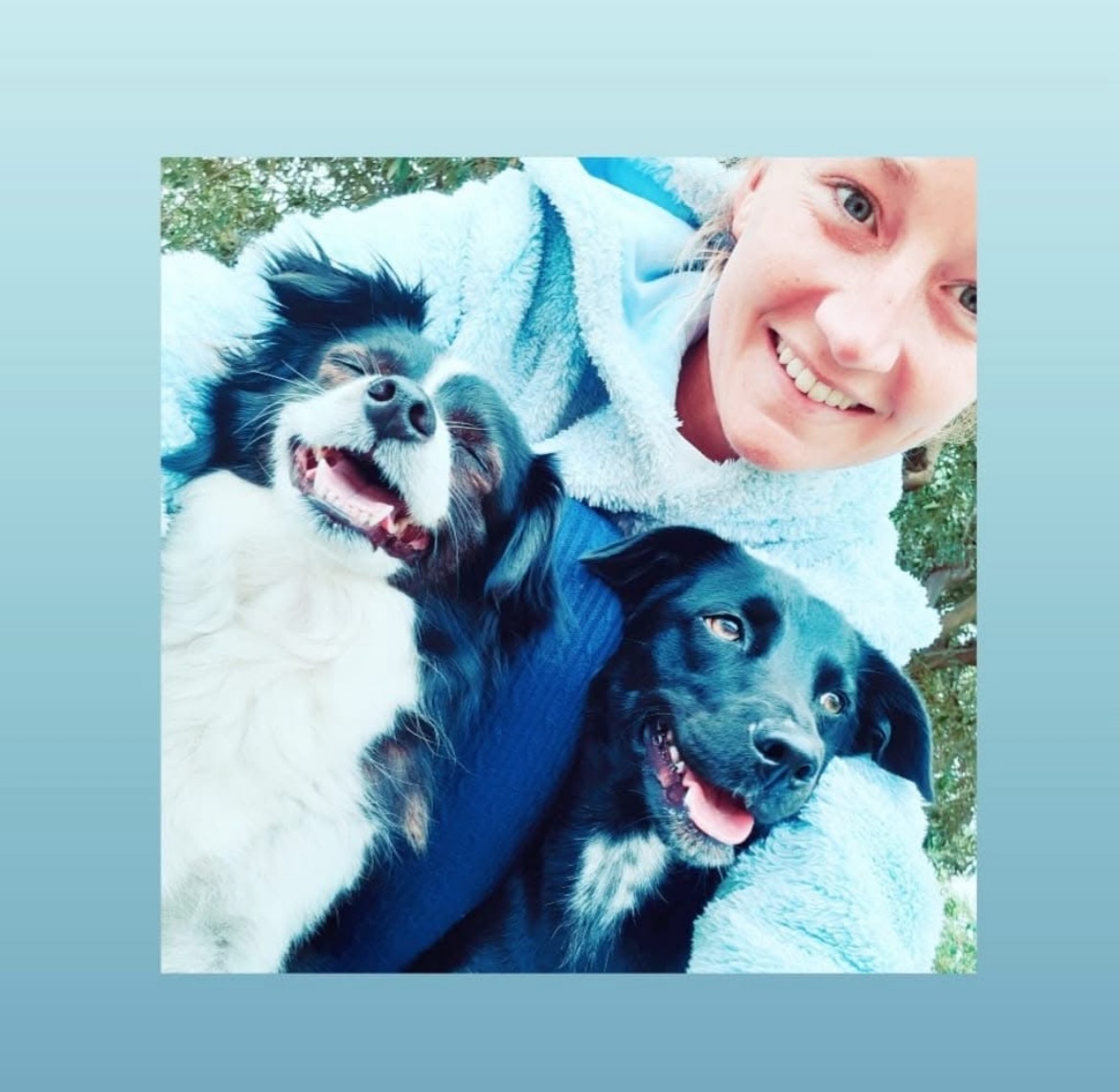 Beth smiling with her two dogs